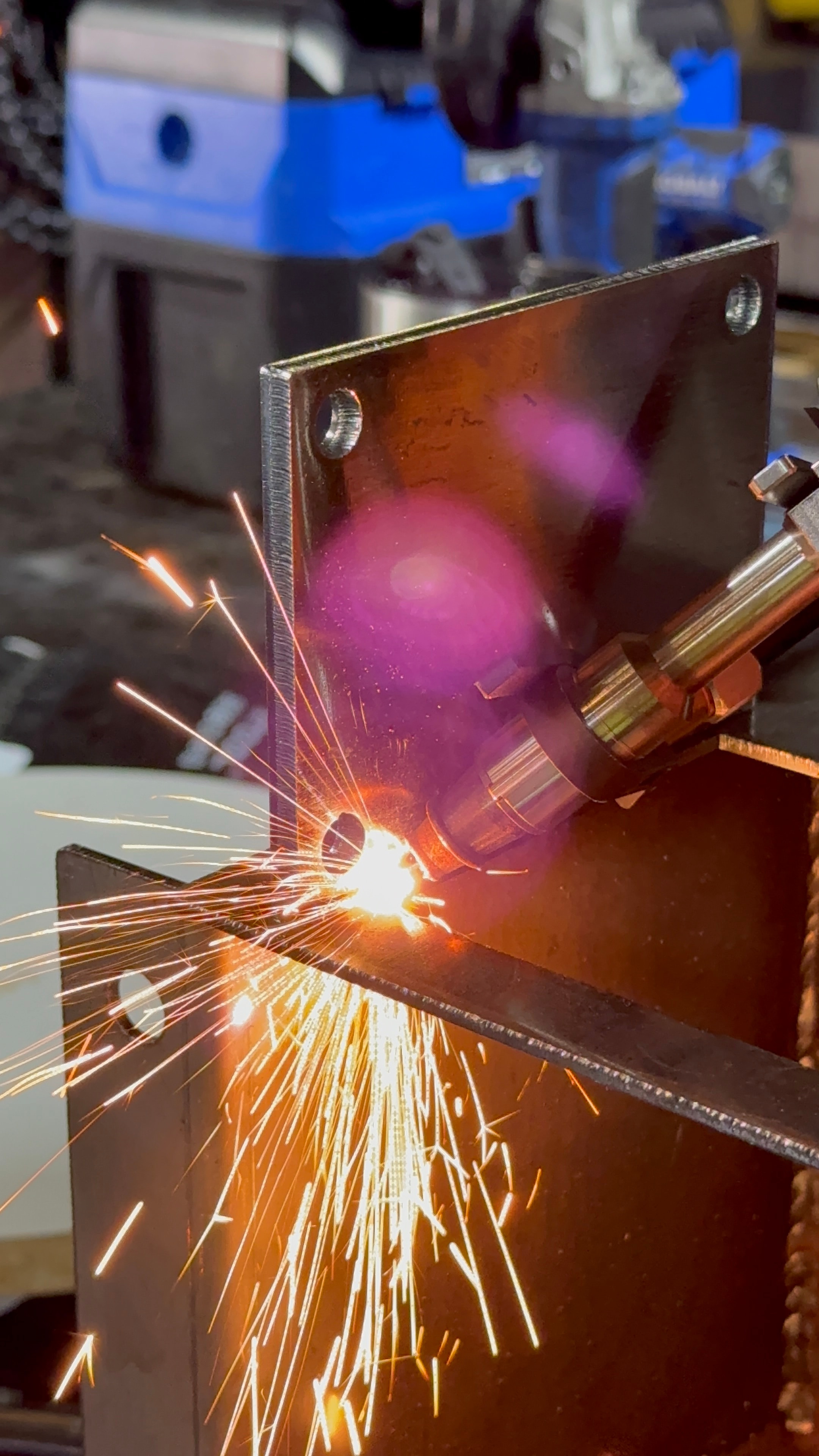 Laser welding sparks flying metal fabrication shop