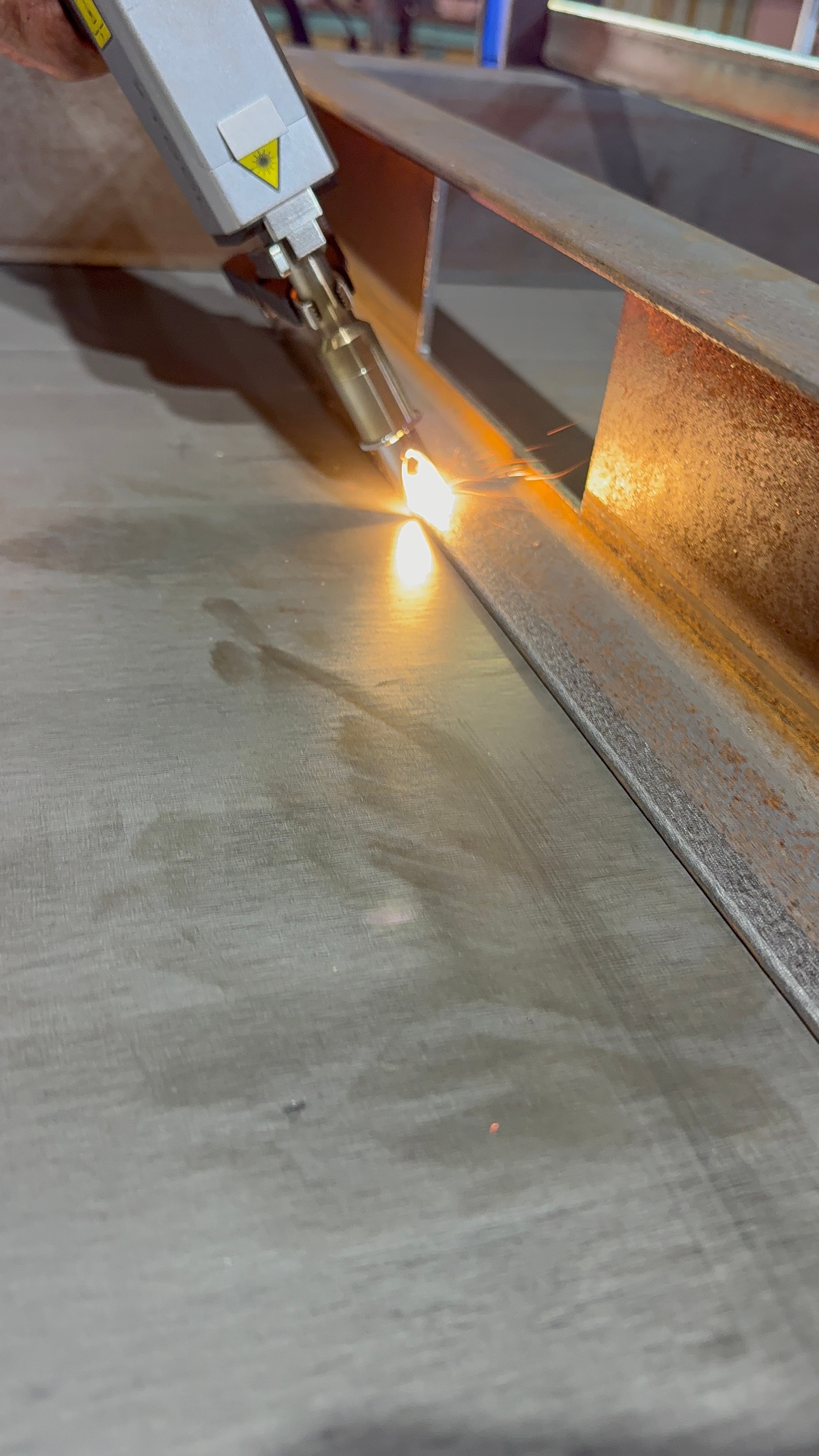 Laser welding metal sheet close-up bright glow
