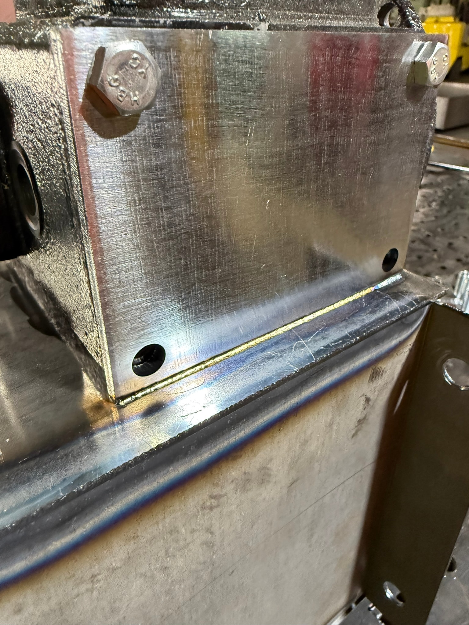 Laser welded steel bracket assembly with heat tint and bolts