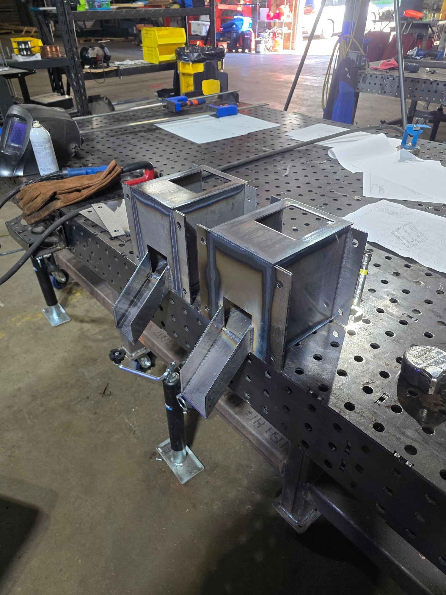 Fabricated steel assembly on a welding fixture table in the shop